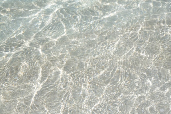 Crystal clear water texture background - water surface with ripple